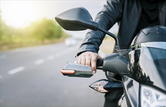 Close up of hands of biker on the handlebars of a motorcycle outdoors