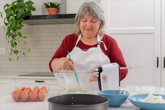 Female cook in white apron beating eggs in a bowl with a spatula