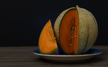 Cantaloupe melon on black background dark food
