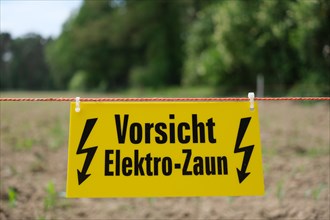 Sign with inscription Caution Electric Fence