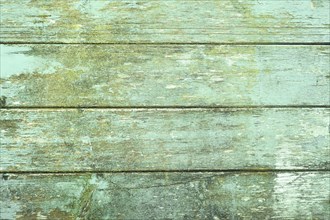 Wooden background with green colored horizontal planks and chipped paint