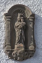 Religious sculpture of Mary with the Child Jesus on a house wall