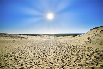 View of bright sun over nordic dunes of Curonian spit