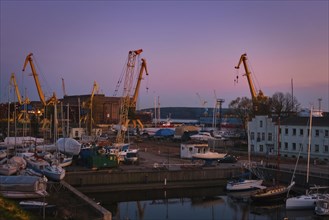 Beautiful sunset port area with portal cranes