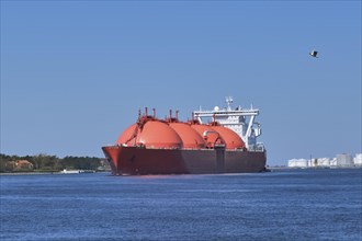 LNG or liquified natural gas tanker entering port on a sunny day in Klaipeda
