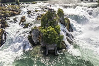 Visitors on the rock in the Rhine Falls waterfall