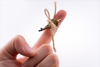 Human figure tied to a hand on a white background