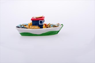 Little colorful model boat with windows on white background