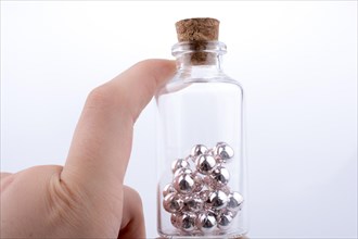 Little perfume glass bottle in hand on a white background