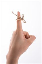 Hand tied with a thread like a ribbon on a white background