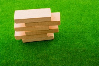 Wooden dominos on green grass