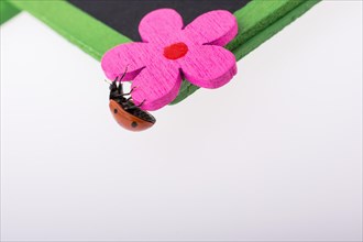 Beautiful photo of red ladybug walking on a fake flower