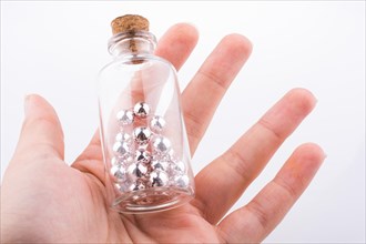 Little perfume glass bottle in hand on a white background