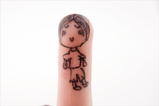 Child figure drawn on a finger tip with black color