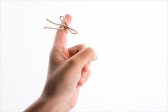 Hand tied with a thread like a ribbon on a white background