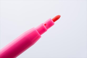 Felt-tip pen of pink color on a white background