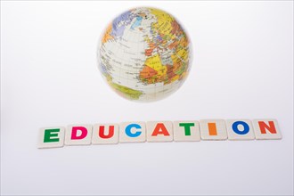 Little colorful model globe and the word of Education