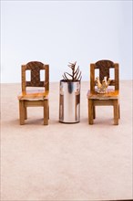 Brown color wooden toy chairs on brown background