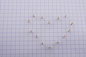 Nails make hole on paper forming a heart shape