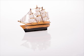 Little model sailboat on a white background