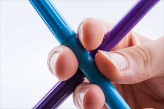 Color felt-tip pens make a cross on white background