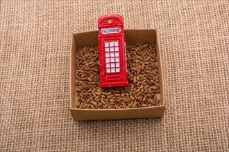 Red color phone booth in a box on a canvas background
