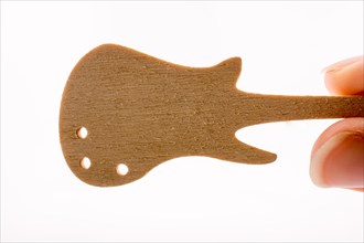 Mini wooden guitar model in hand on a white background