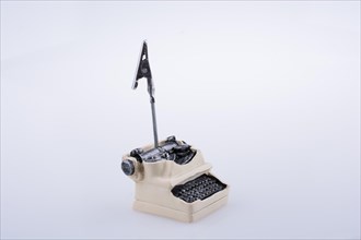 Retro syled tiny typewriter model on a white background
