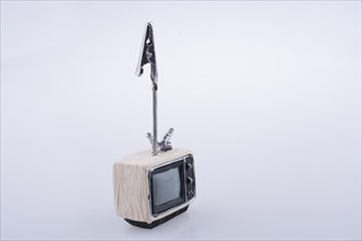 Retro syled tiny television model on a white background