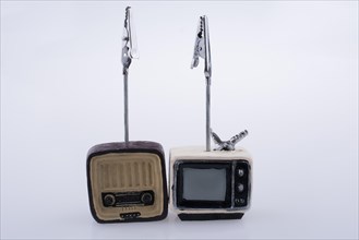 Retro syled tiny television and radio model on a white background