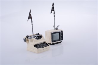 Retro syled tiny television and typewriter model on a white background
