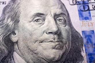 Close up of Benjamin Franklin face on 100 US dollar bill