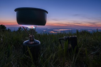 Gas cooker boiling water while camping in the mountains