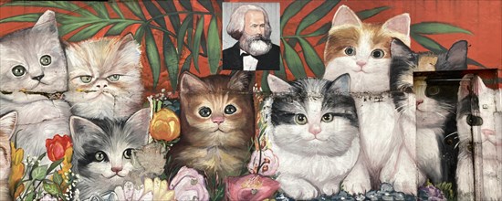 Street art by an unknown artist showing many cats with a portrait of Karl Marx