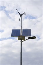 Street lamp with solar panels and small wind turbine