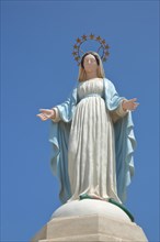 White statue of Our Lady with crown and halo