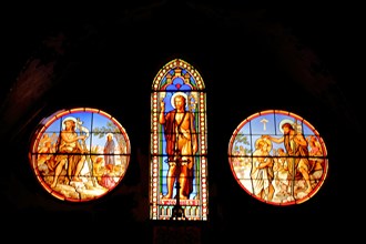 Three stained glass windows with John the Baptist of Saint-Dame-du-Bon-Remède Church