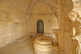 Cloister with baptismal font and figure