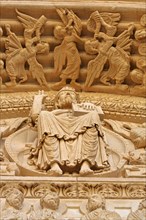 Sculptures Majastas Domini with angel and trumpets at the tympanum