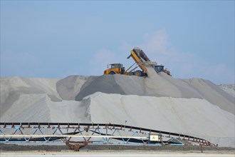 Dump truck unloading salt at a salt mine for salt extraction