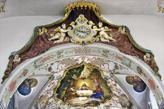 Ceiling frescoes and clock in the Holy Trinity Parish Church in Sulzberg