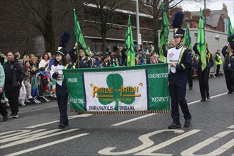 An Indiana group carries a flag with the words Pride of the Irish at the St Patrick's day parade in Dublin in 2023