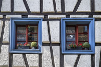 Windows decorated with flower boxes on a half-timbered house in the old town of Raolfzell on Lake Constance