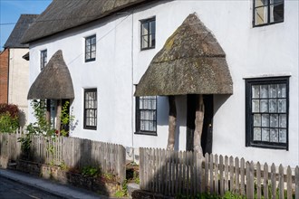 Traditionally built English terraced houses with thatched roofs