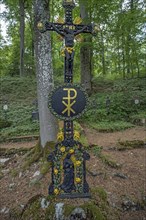 Historical grave cross around 1830 in a funeral forest