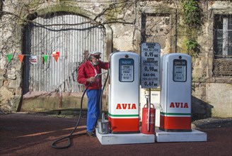 Antique Avia fuel pumps and service station attendant during the Embouteillage de la Route Nationale 7