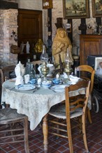 Old dining room with antique furniture and vintage dinner set