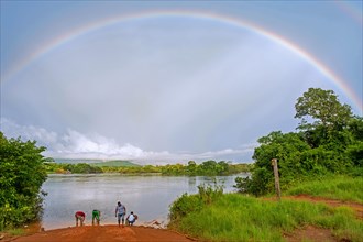 Rainbow and locals waiting for ferry on the Essequibo River in the rainy season along the Linden-Lethem dirt road