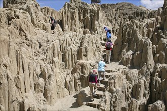 Tourists visiting the eroded limestone rock formations in the Valley of the Moon