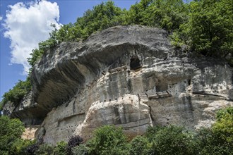 Caves and terraces in rock face of the Grottes du Roc de Cazelle